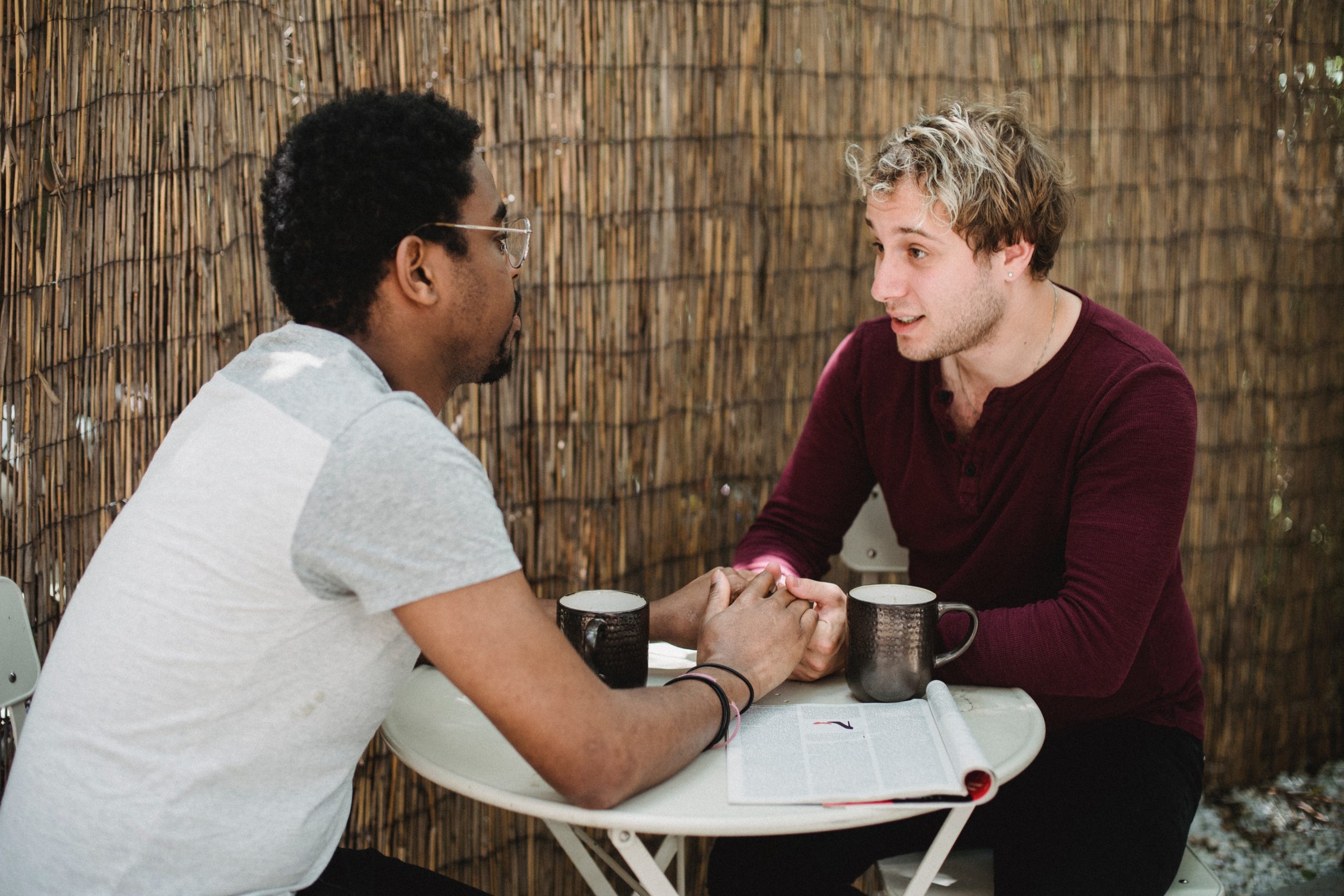 Couple at a coffee shop holding hands