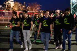 group of students walking with black neon nights t shirts