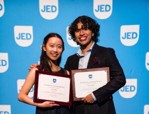 Audrey Wang and Jose Caballero JED Student Voice of Mental Health award recipients standing together smiling while holding their certificates