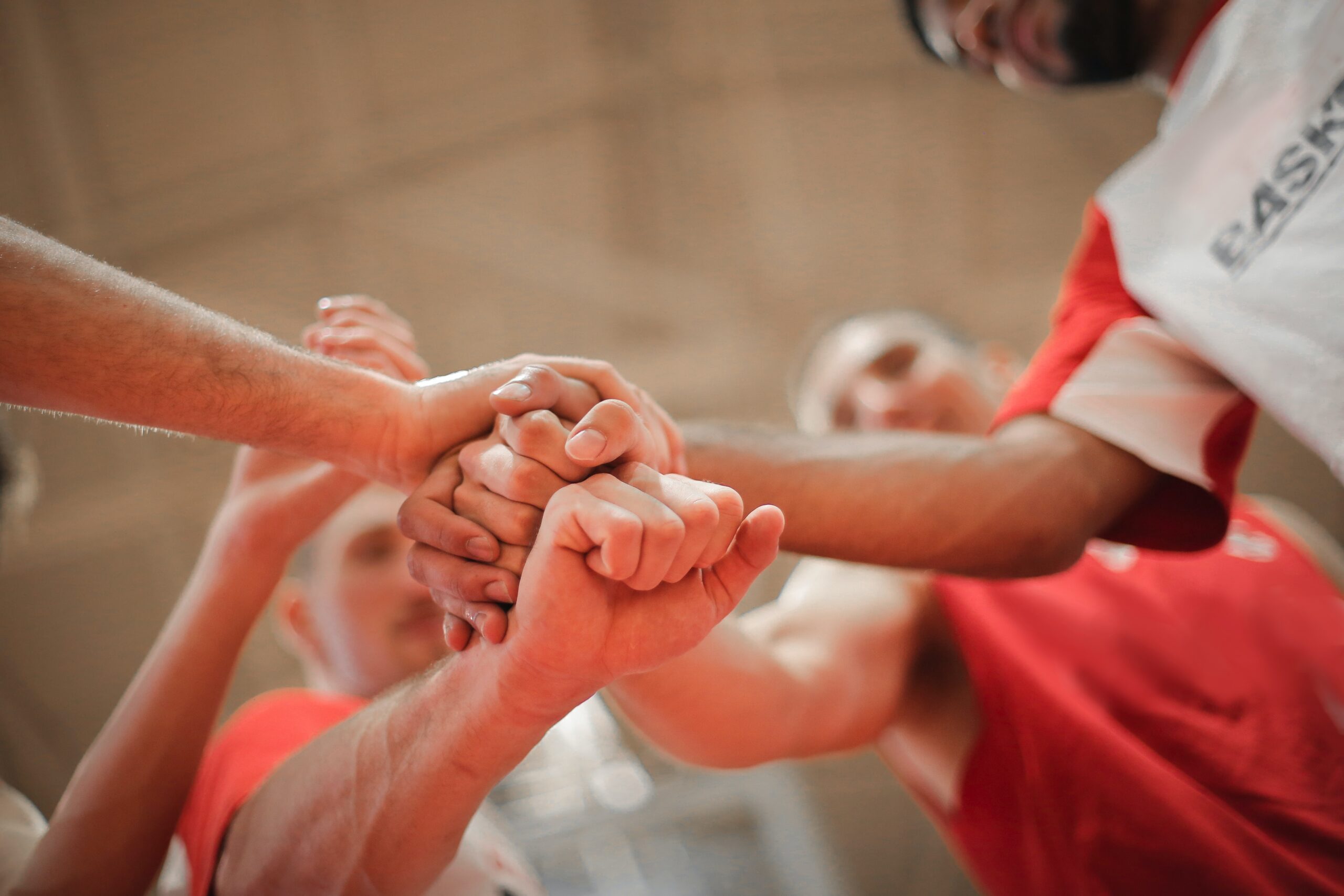 A team joining hands as a sign of team work