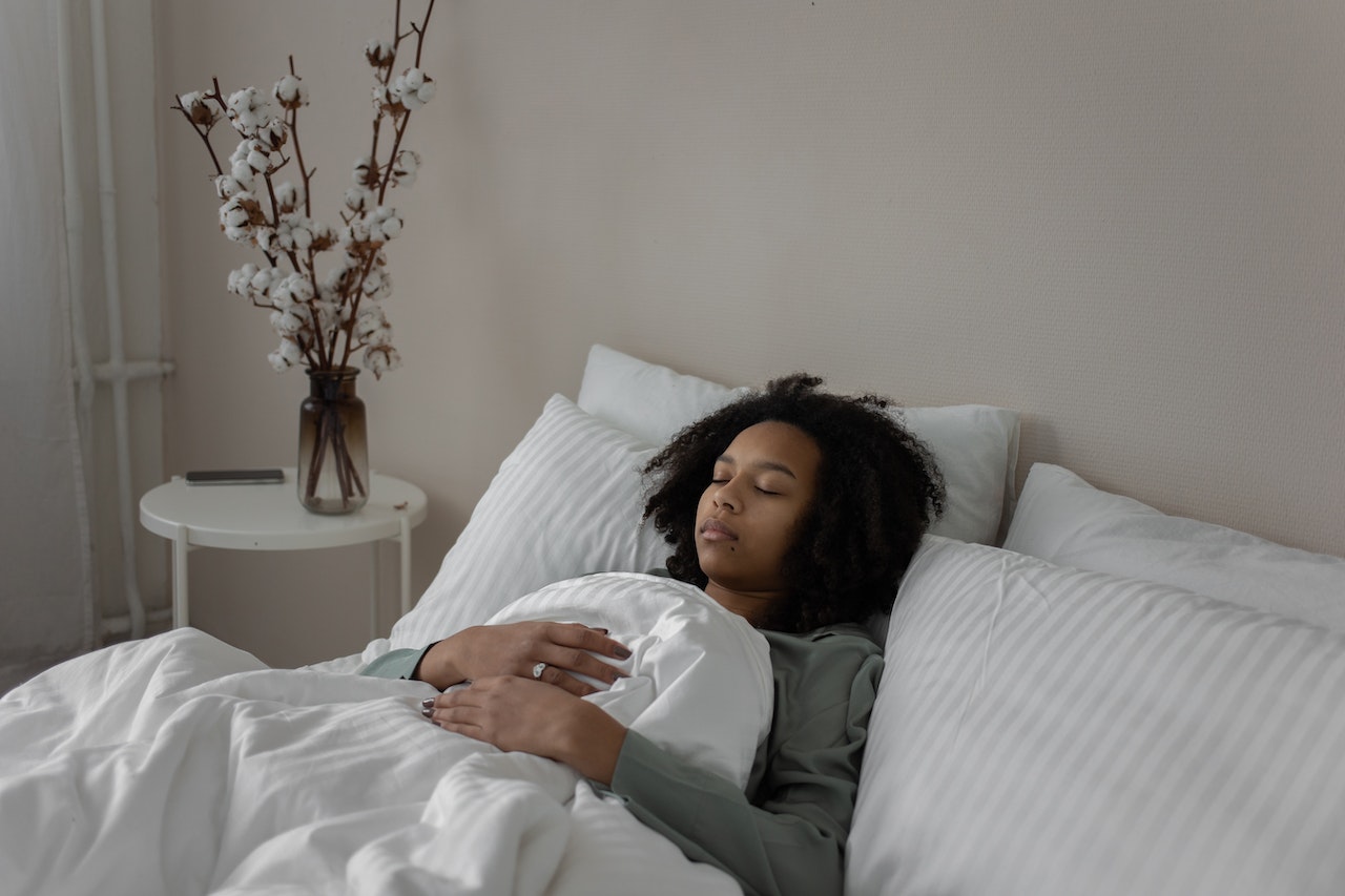 black woman lying in bed sleeping