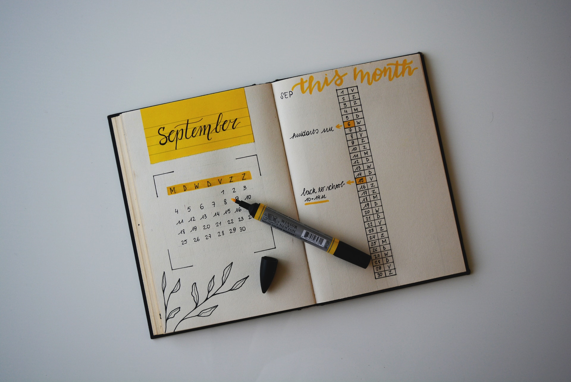 planner opened on the month of september with an open pen covering both pages