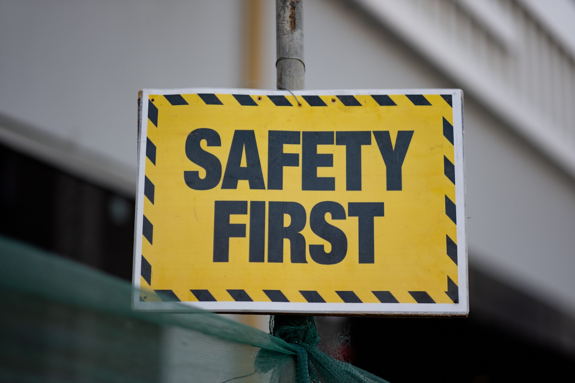 yellow safety first sign