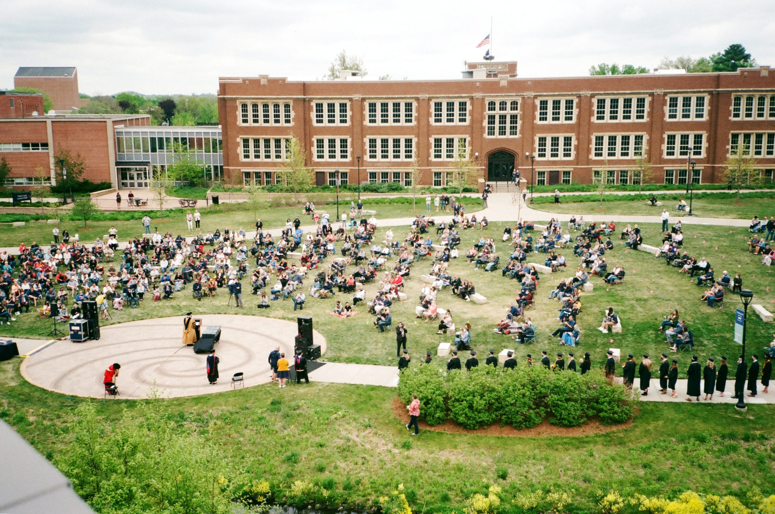 A college graduation ceremony on a grassy campus