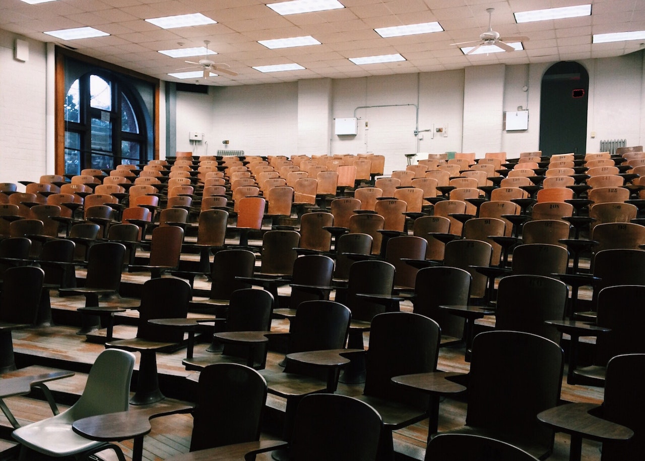 empty college classroom with tan colored seats