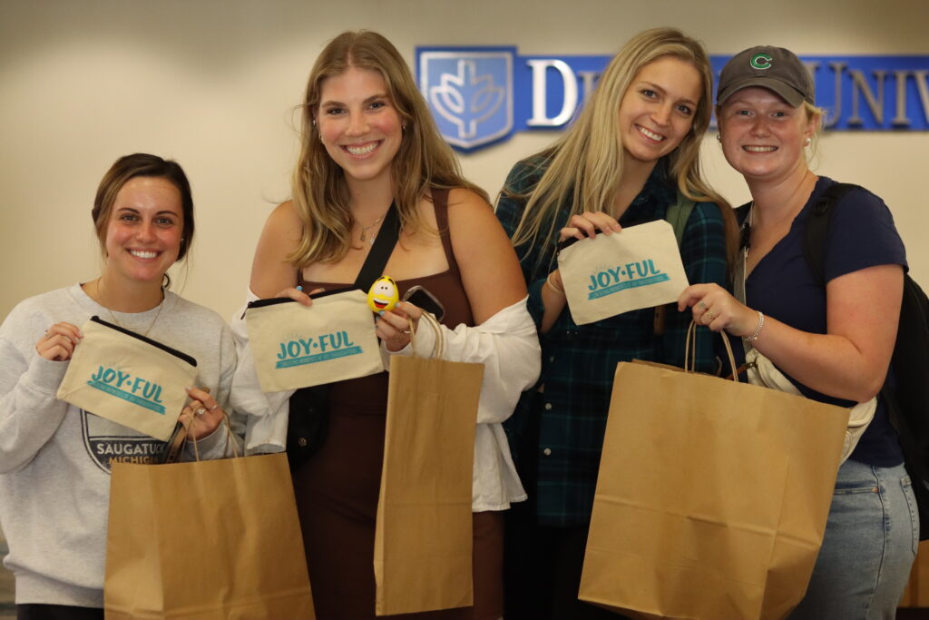 A group of students at DePaul University show off the Joy-Ful items they received as part of the JED and Chartwells back-to-school initiative.
