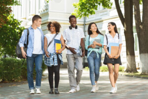 Group of college friends walking outdoors in university campus