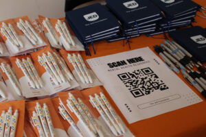 A table full of Chegg pen and JED swag items that were given out during Student Mental Health Week.