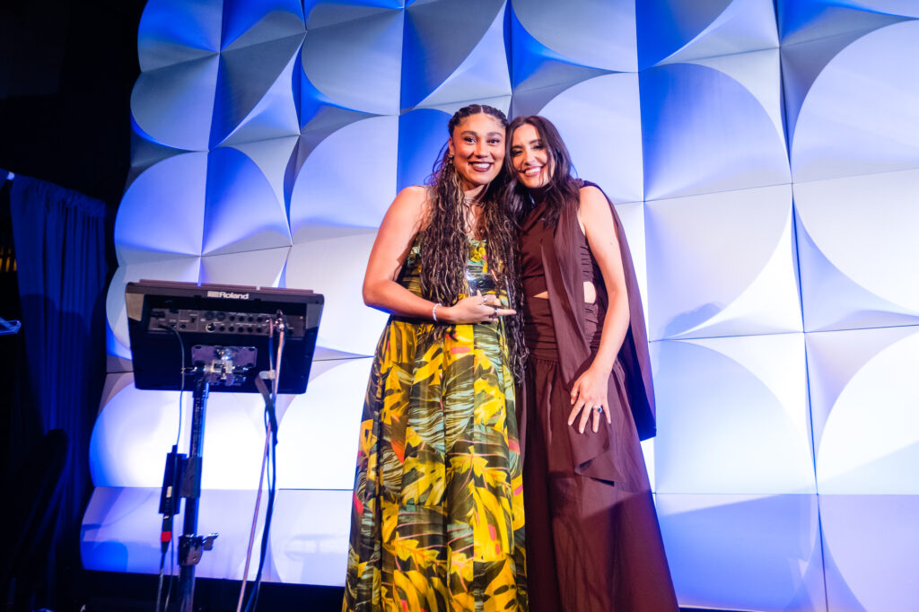 Ally Love and Savannah Sellers pose for cameras as Love accepts the 2025 Voice of Mental Health Awards.