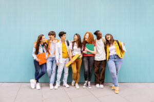group of students standing outside talking to one another