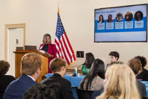 Zainab Okolo of the JED Foundation standing at podium speaking to congressional briefing attendees