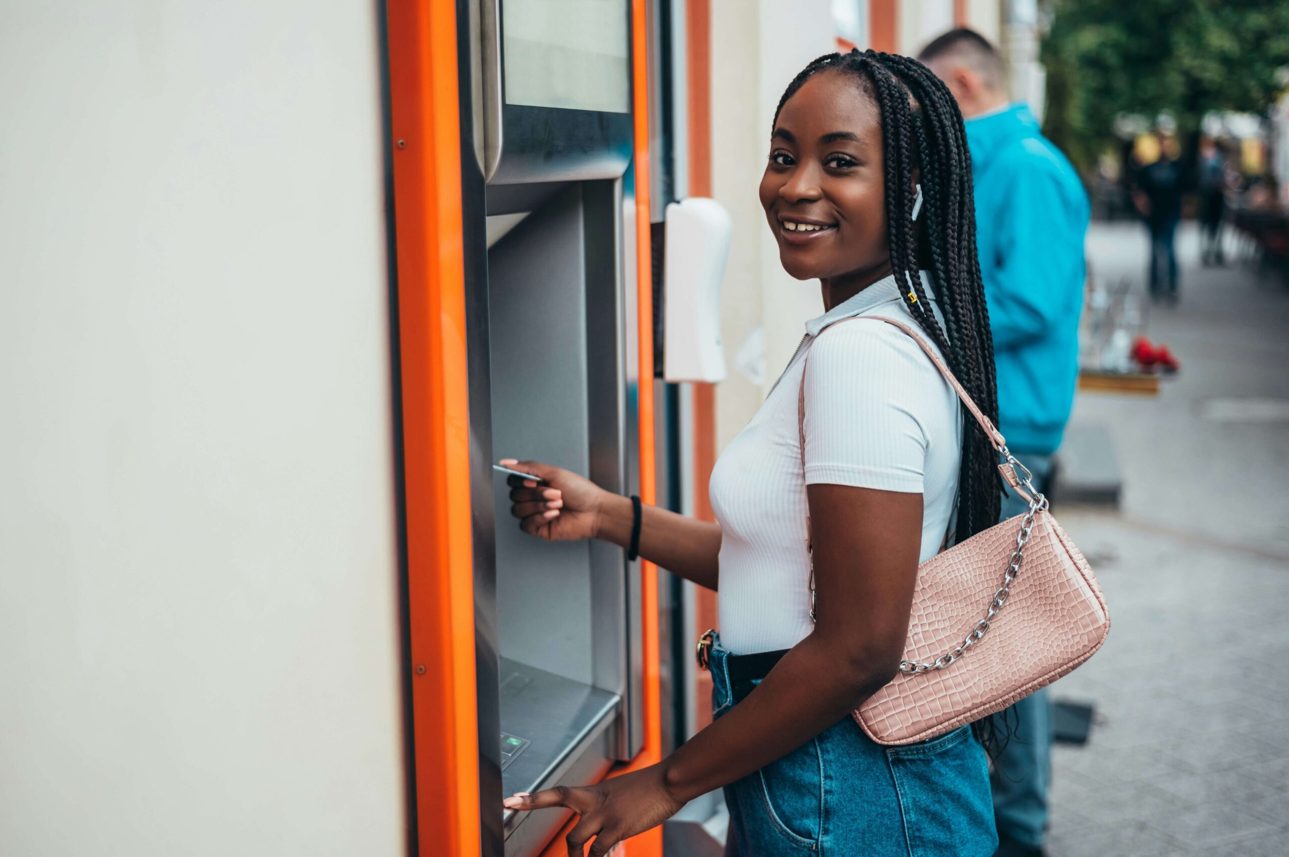 Teen girl uses an ATM