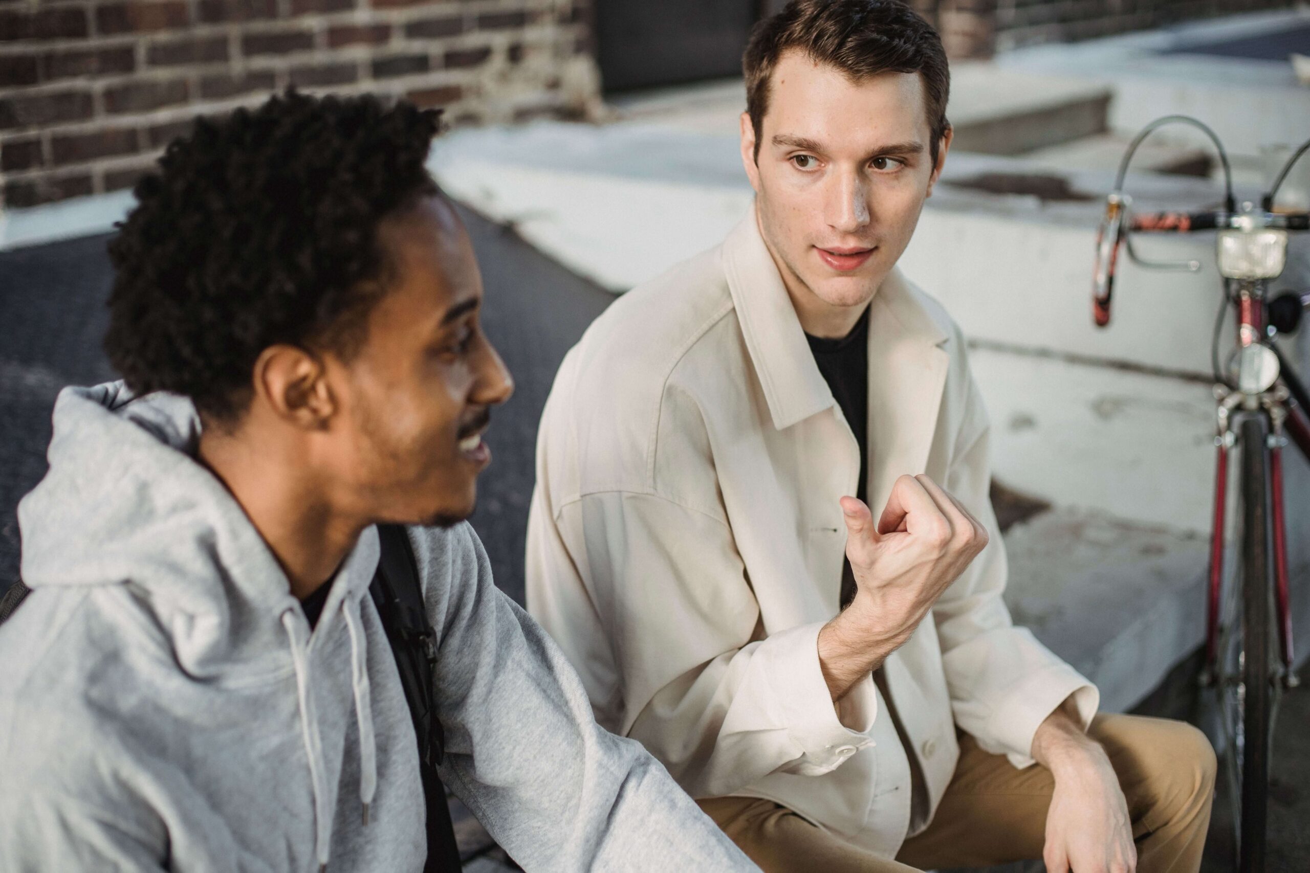 Two young men are talking to each other